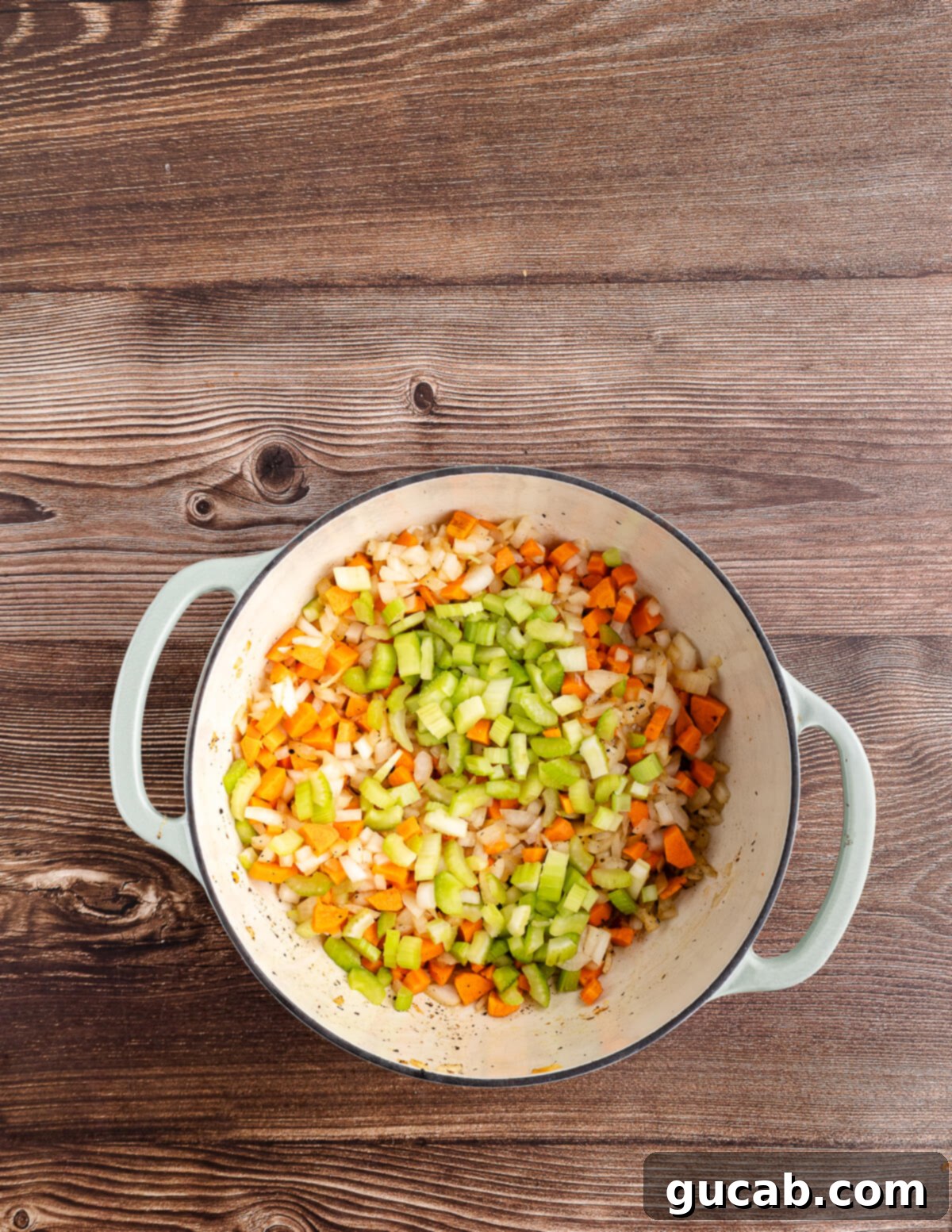 diced celery, onion, and carrots in a dutch oven. 