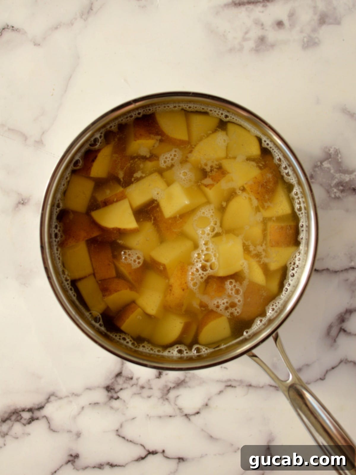 Creamy Almond Mashed Potatoes 5 cut up potatoes in a pot with water