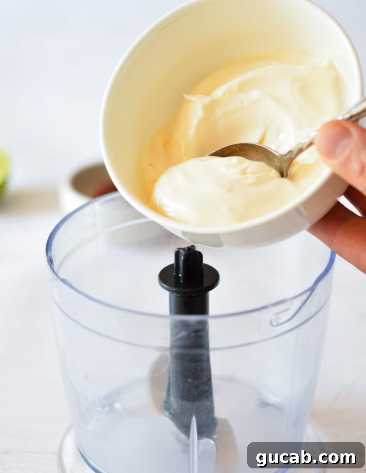 Homemade Chipotle Mayo 6 pouring mayo into a small food processor.