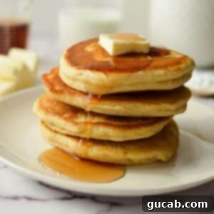 A perfect stack of golden brown gluten-free pancakes, invitingly fluffy.