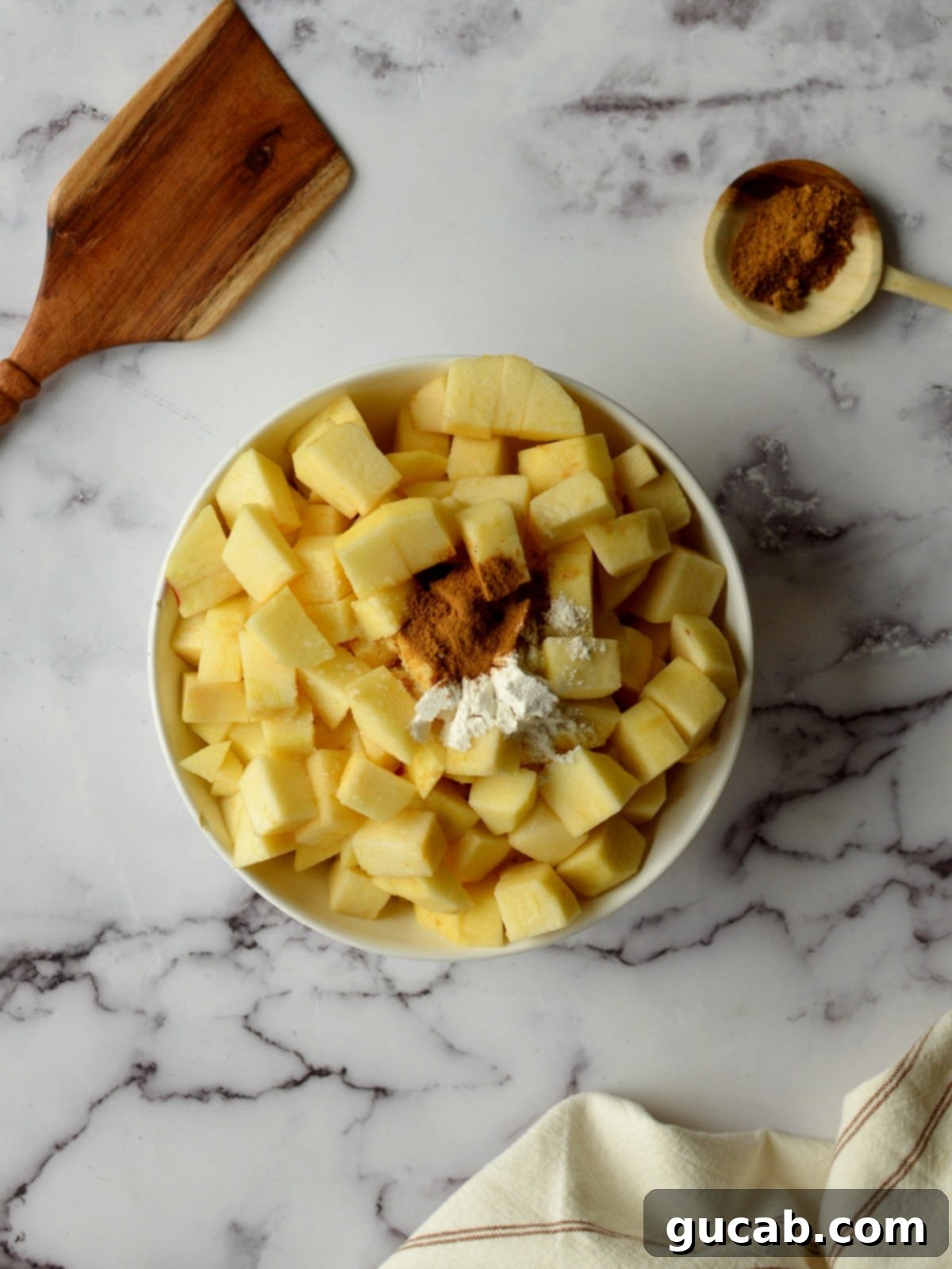 Wholesome Apple Crumble 4 apples, cinnamon, and tapioca starch in a bowl