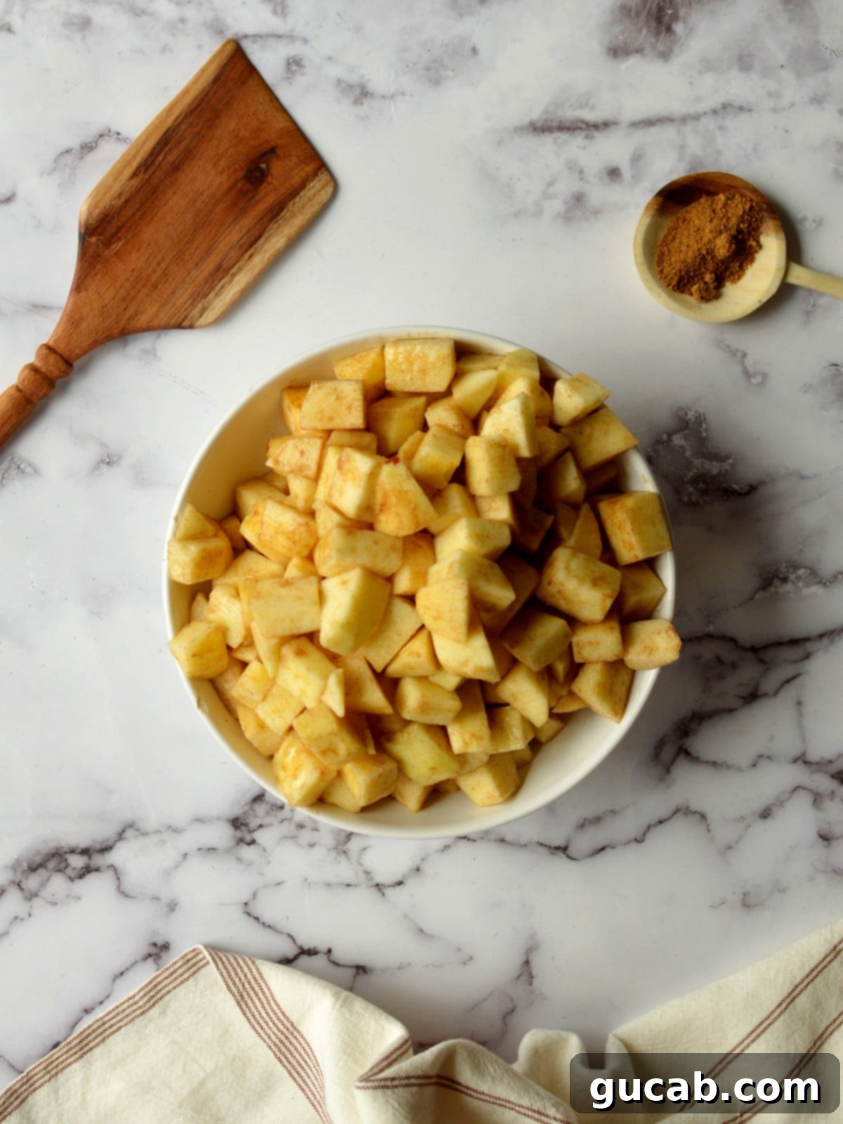Wholesome Apple Crumble 5 a bowl of apples coated in cinnamon