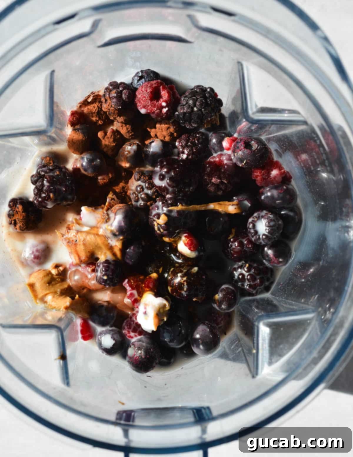 Chocolate Berry Bliss 4 frozen berries, peanut butter, cocoa powder, and almond milk in a blender.
