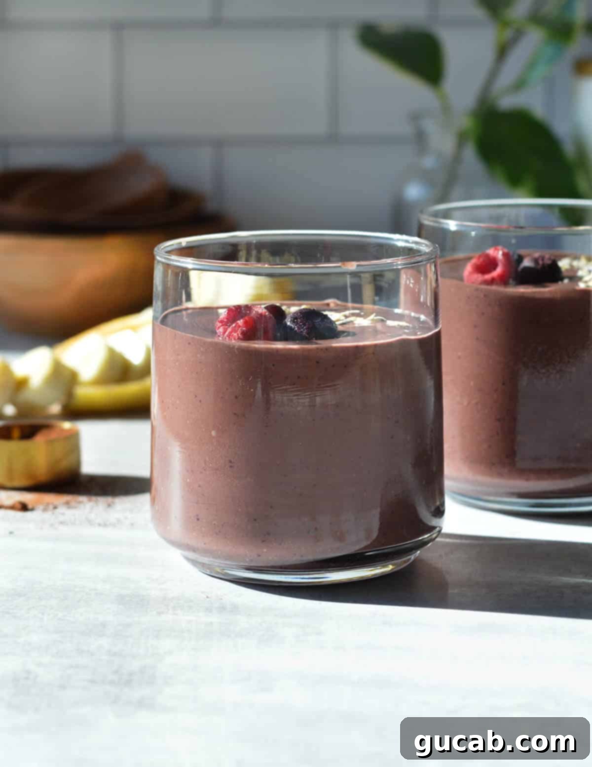 Chocolate Berry Bliss 8 chocolate berry smoothies in glasses with berries on top.