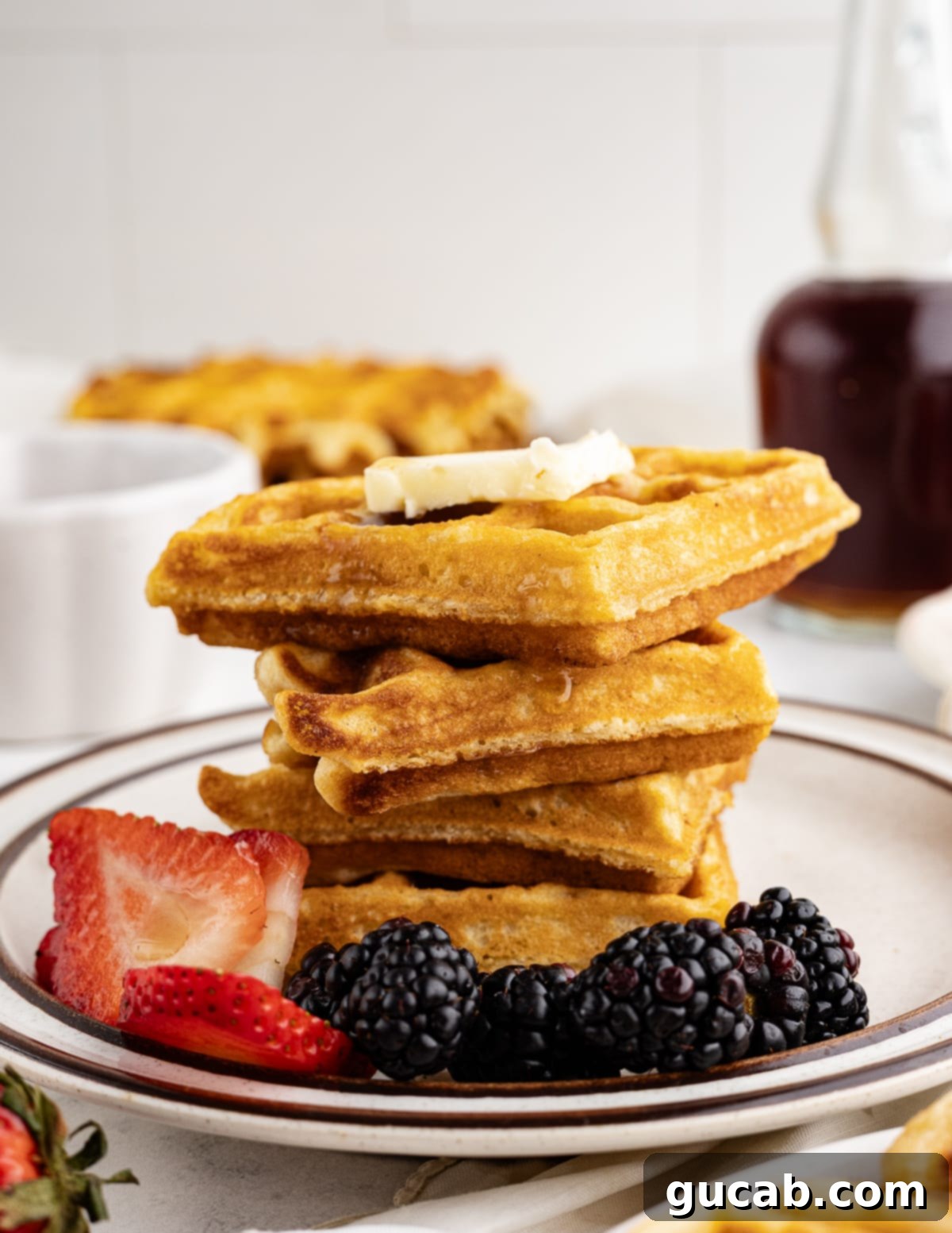 A perfectly arranged stack of golden, freshly cooked gluten-free waffles, showcasing their inviting texture.