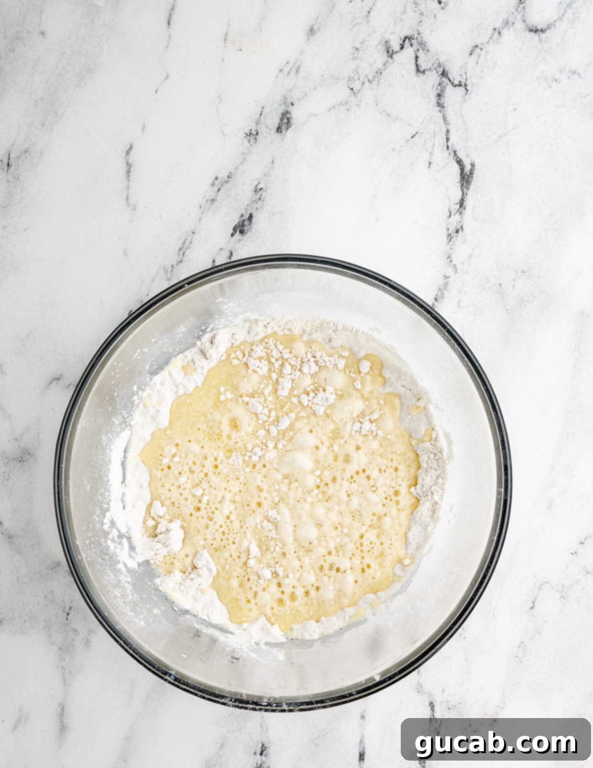A bowl showing the combined dry and wet ingredients for gluten-free waffles, before the egg whites have been folded in.