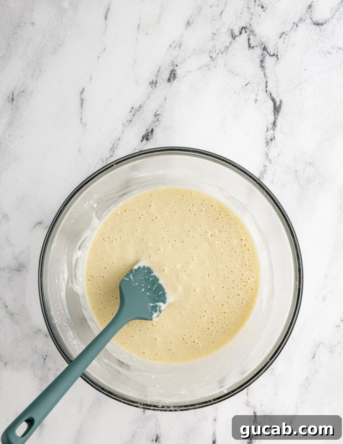 Your New Favorite Gluten-Free Waffle Recipe 10 A bowl of gluten-free waffle batter with a spatula, demonstrating the thick consistency before egg whites are added.