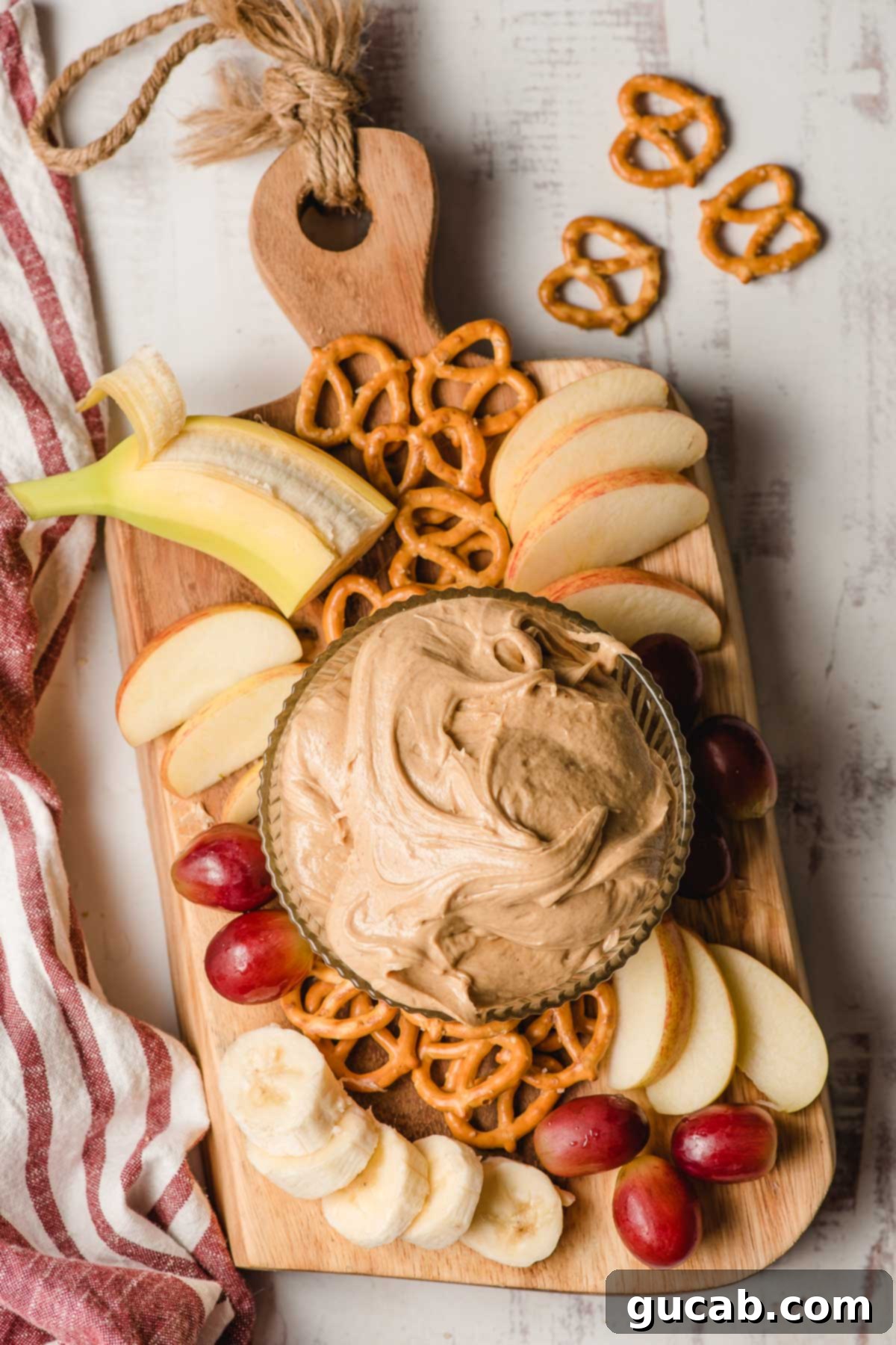 peanut butter dip next to apples and pretzels