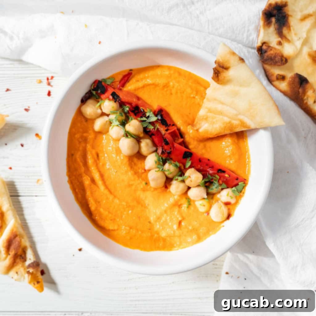a bowl of roasted red pepper hummus