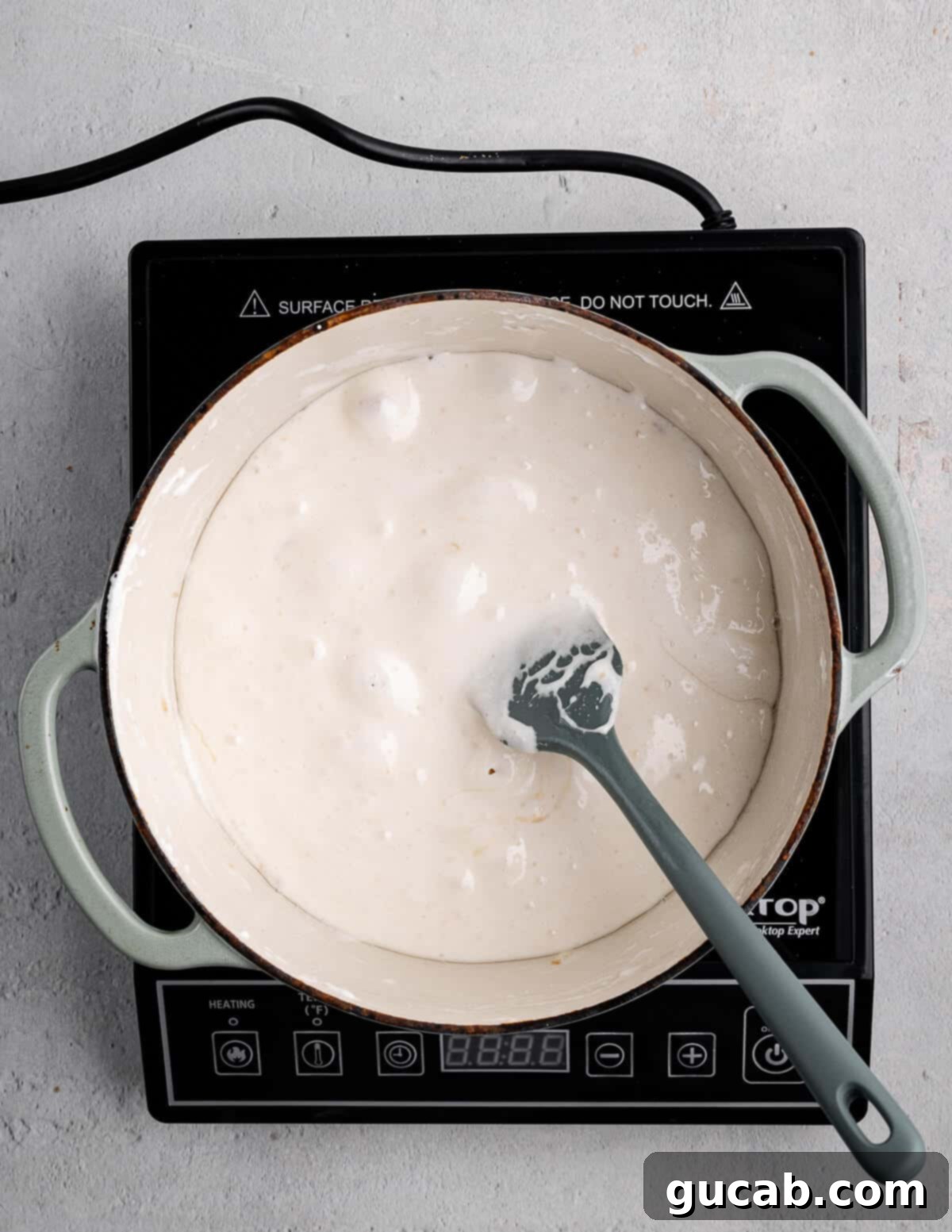 A dutch oven showing a perfectly melted and emulsified mixture of mini marshmallows and coconut oil.