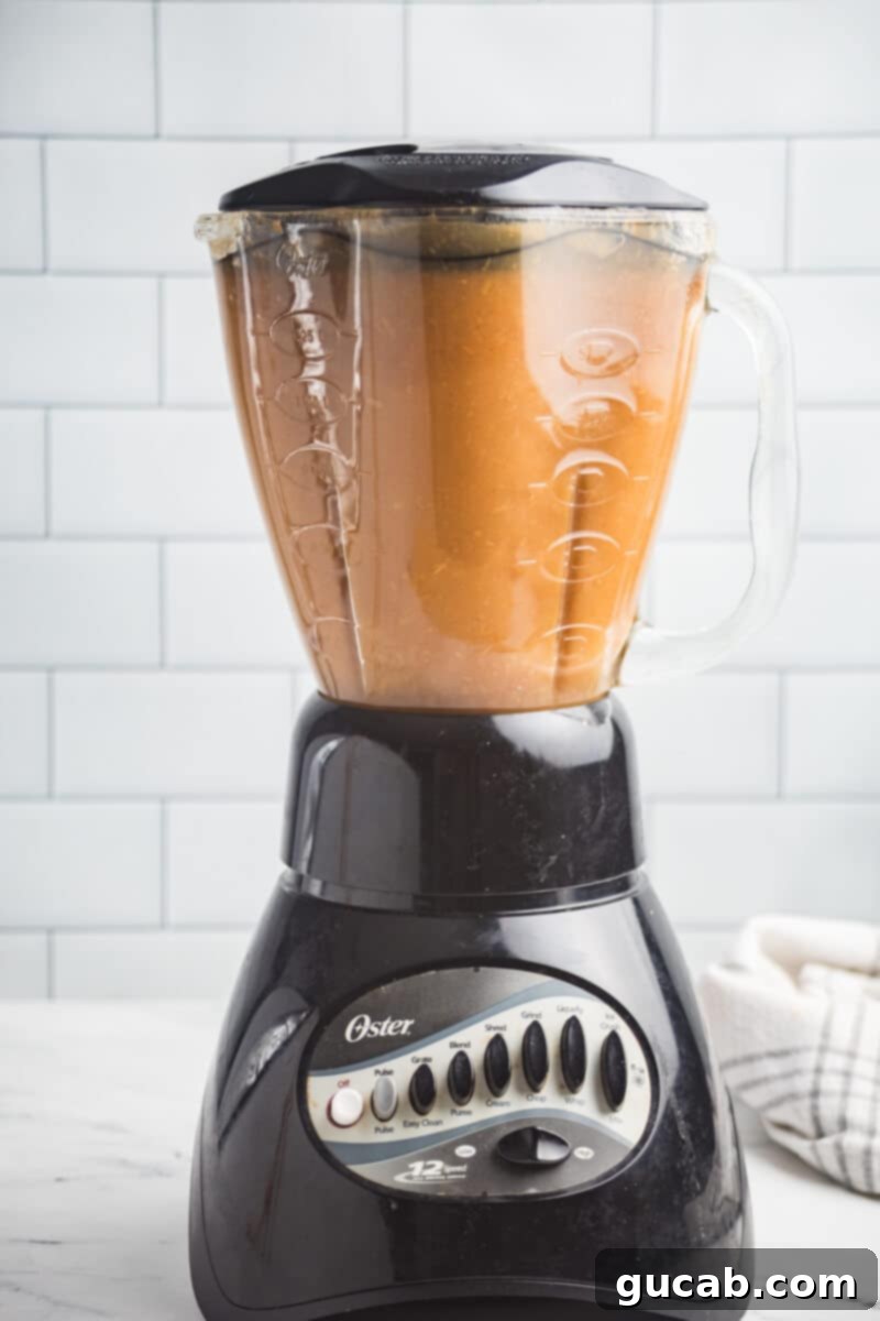 Cooked apple mixture in a blender, before being fully processed into applesauce.
