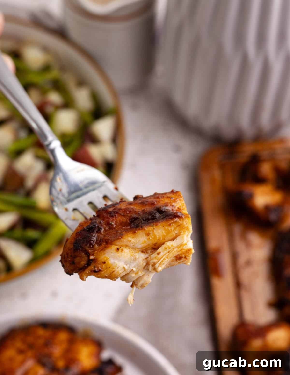 Perfectly Baked Boneless Skinless Chicken Thighs 11 a bite of chicken on a fork.
