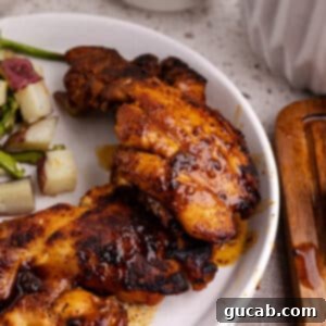 Perfectly Baked Boneless Skinless Chicken Thighs 12 cooked boneless skinless chicken thighs on a plate.