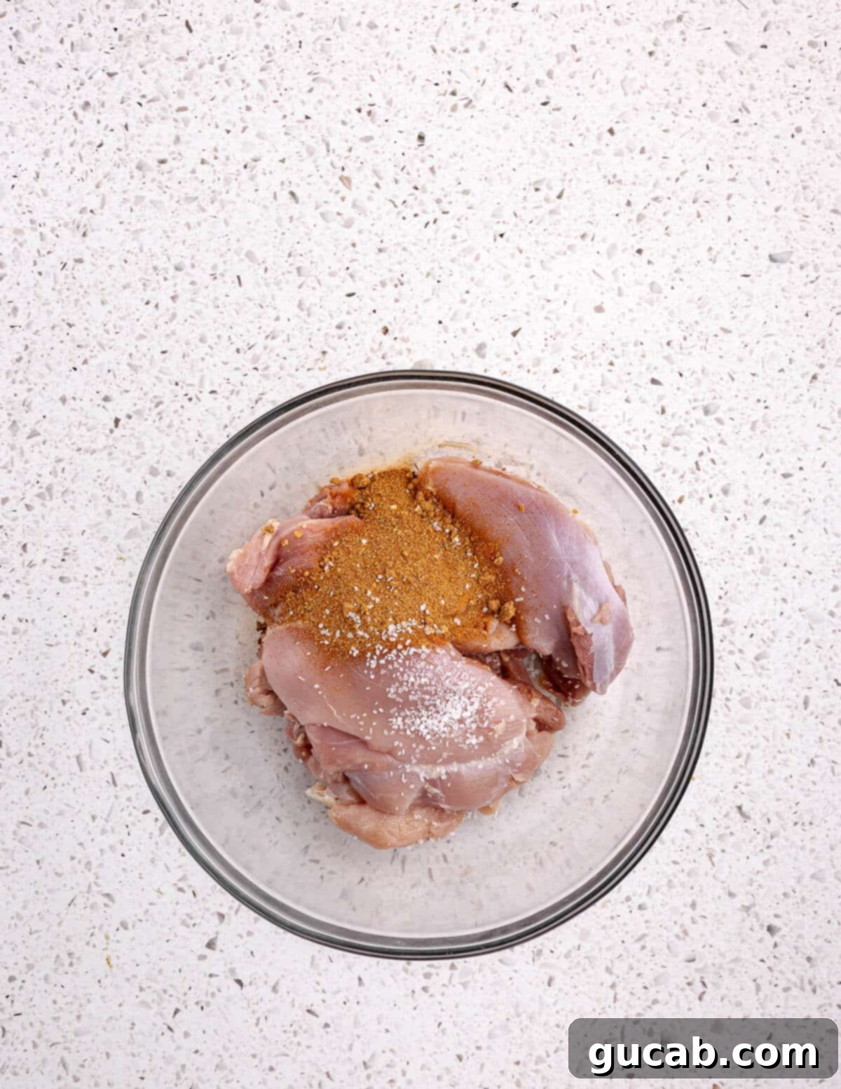 Perfectly Baked Boneless Skinless Chicken Thighs 5 a bowl of chicken thighs with taco seasoning on them.