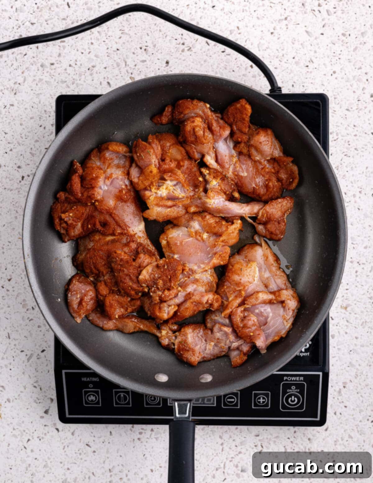 Perfectly Baked Boneless Skinless Chicken Thighs 7 seasoned chicken thighs in a skillet