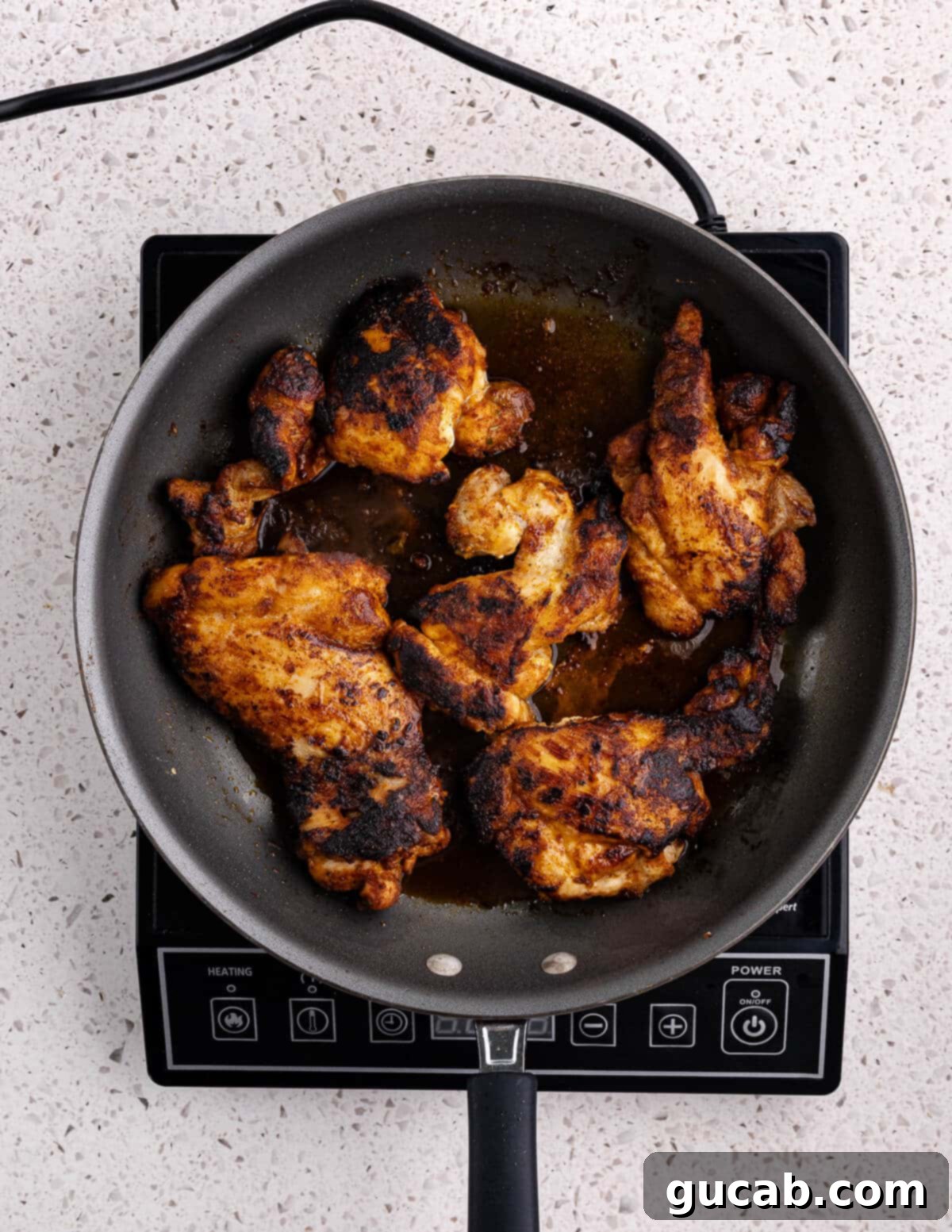 Perfectly Baked Boneless Skinless Chicken Thighs 8 caramelized chicken thighs in a skillet
