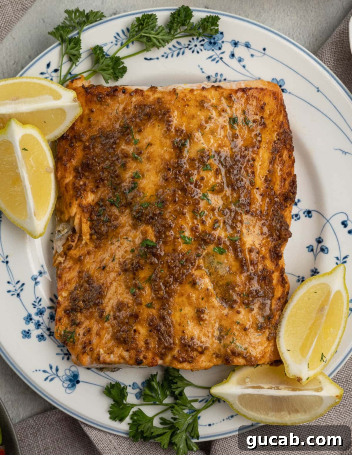 Perfectly cooked salmon on a plate, garnished with fresh lemons. A healthy and delicious meal.