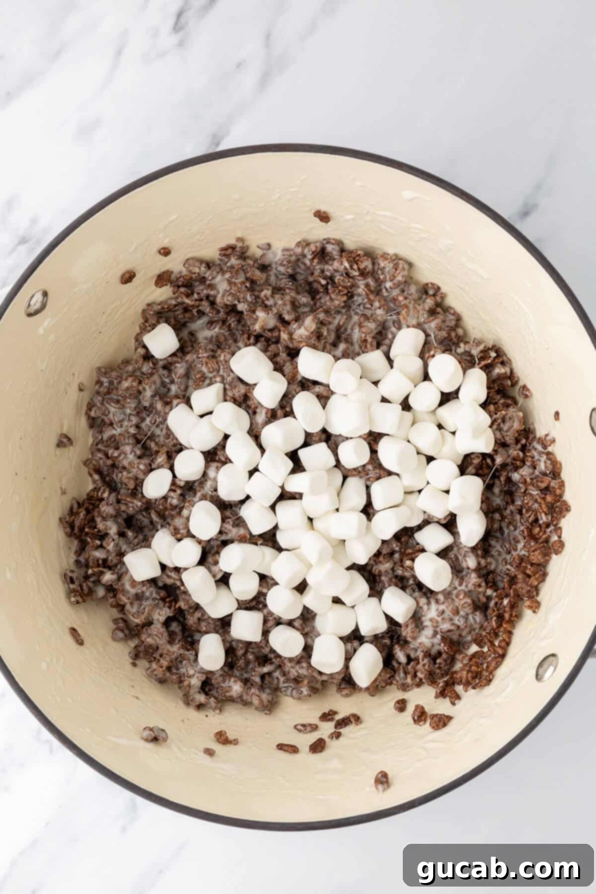 Chocolate rice krispie marshmallow mixture topped with mini marshmallows