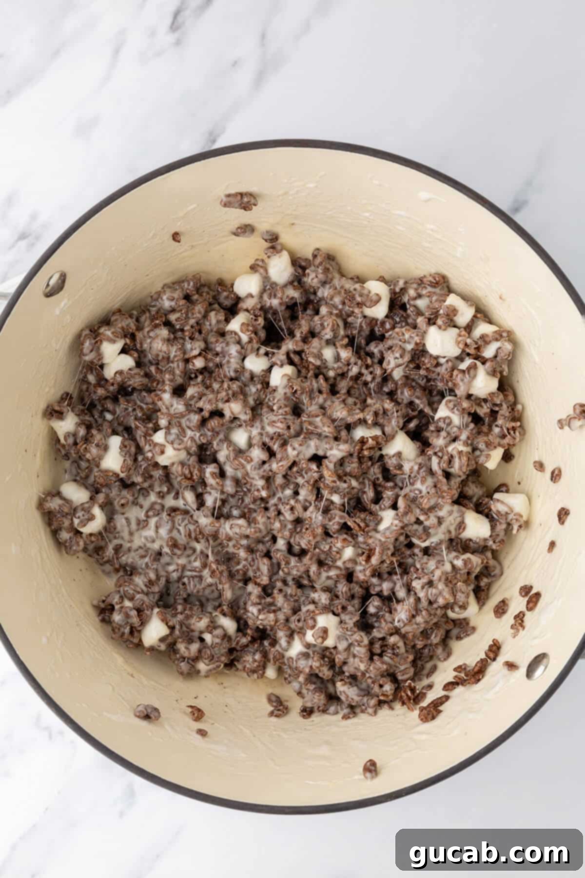 Chocolate rice krispie treat mixture in a Dutch oven