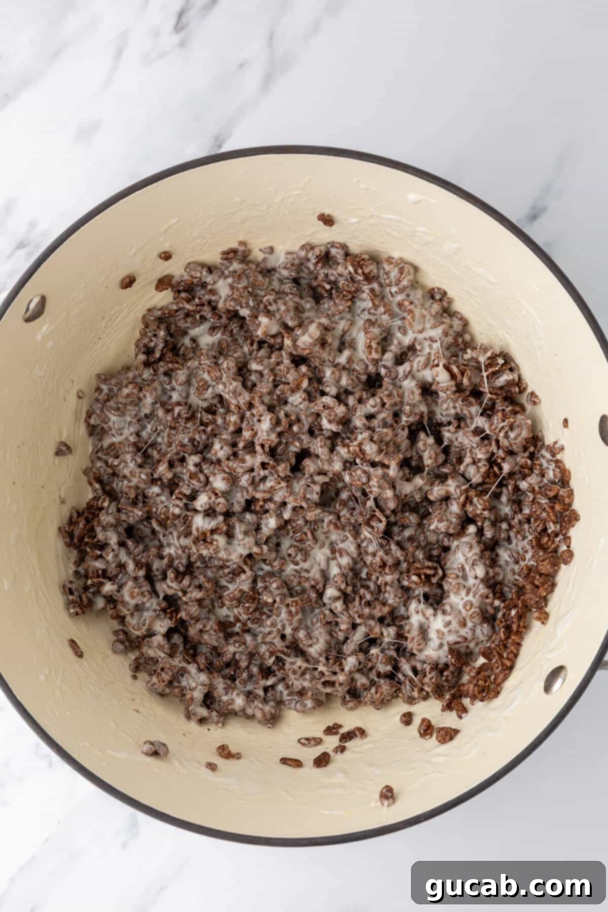 Cocoa Krispies in a Dutch oven coated in marshmallow