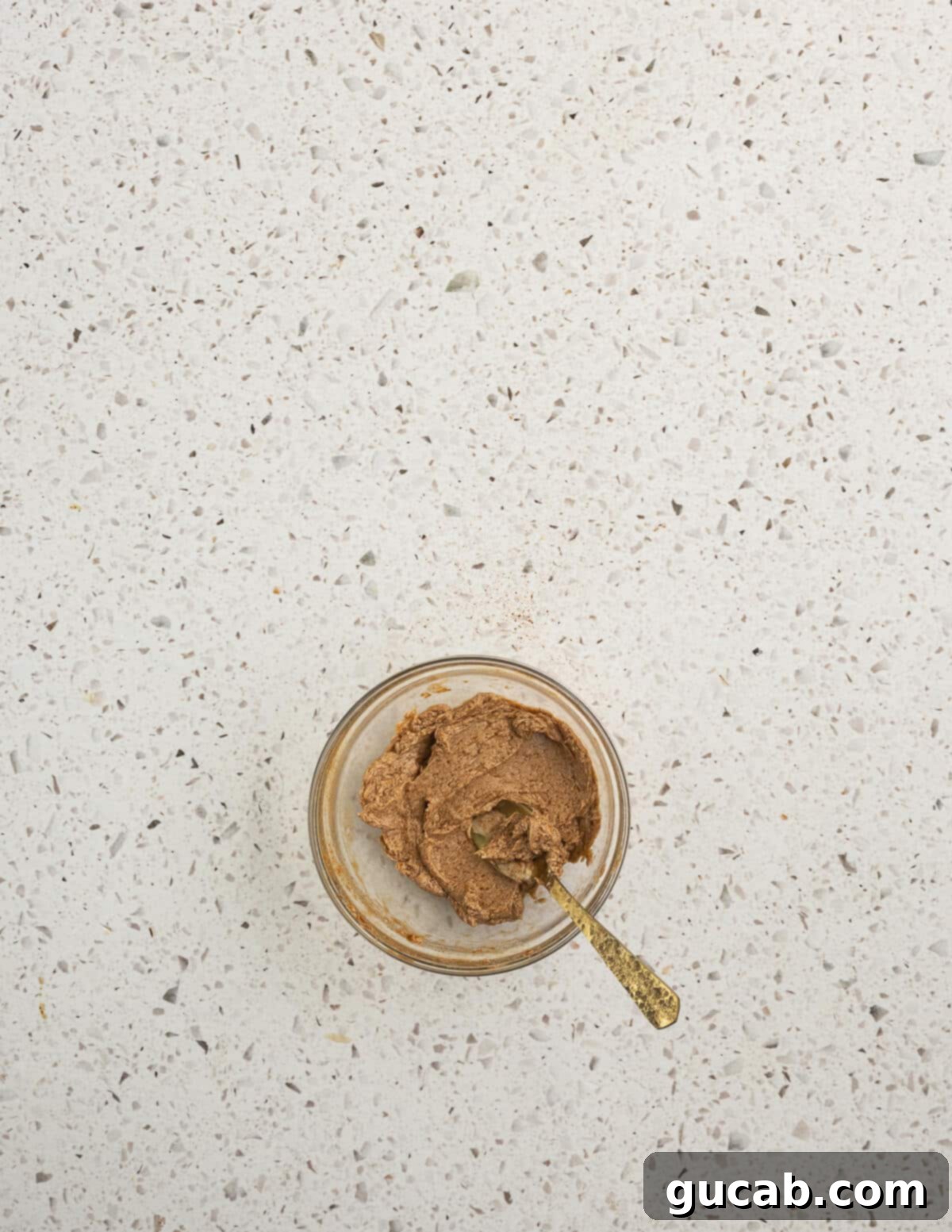 A small bowl filled with creamy cinnamon maple butter, ready to be served with the baked sweet potatoes.