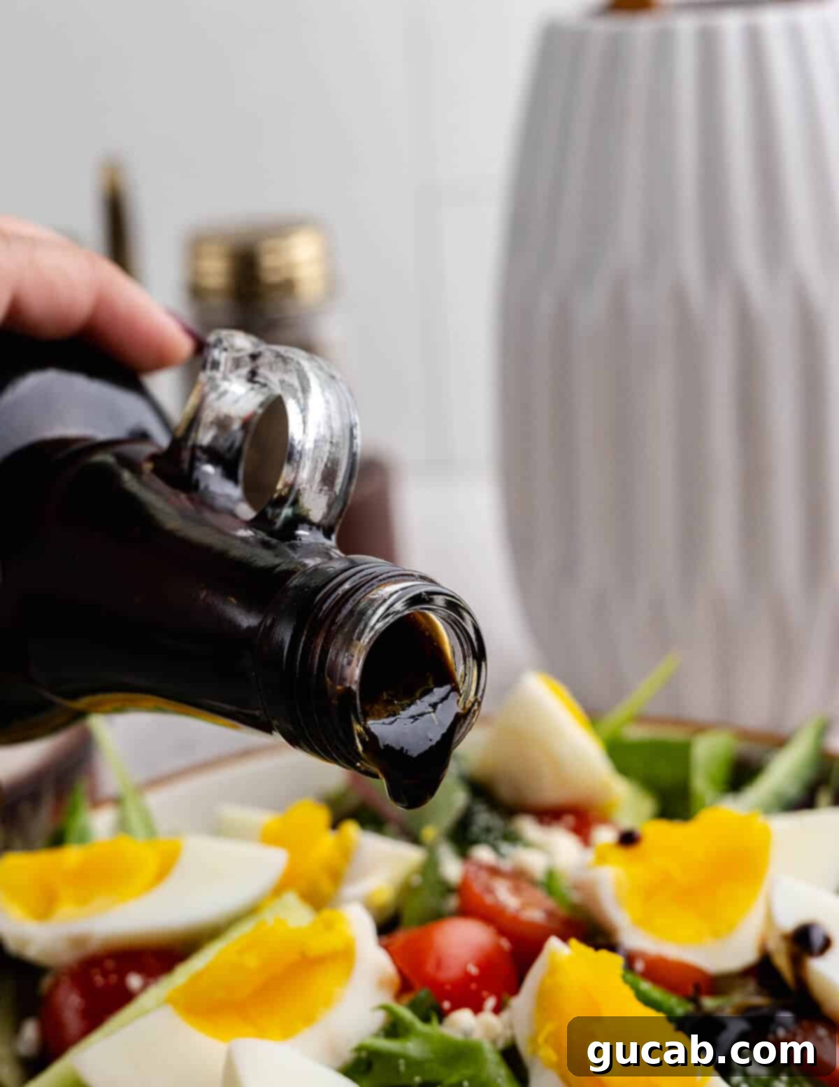 Fig Infusion: A Twist on Vinaigrette 2 Pouring fig vinaigrette onto a fresh salad