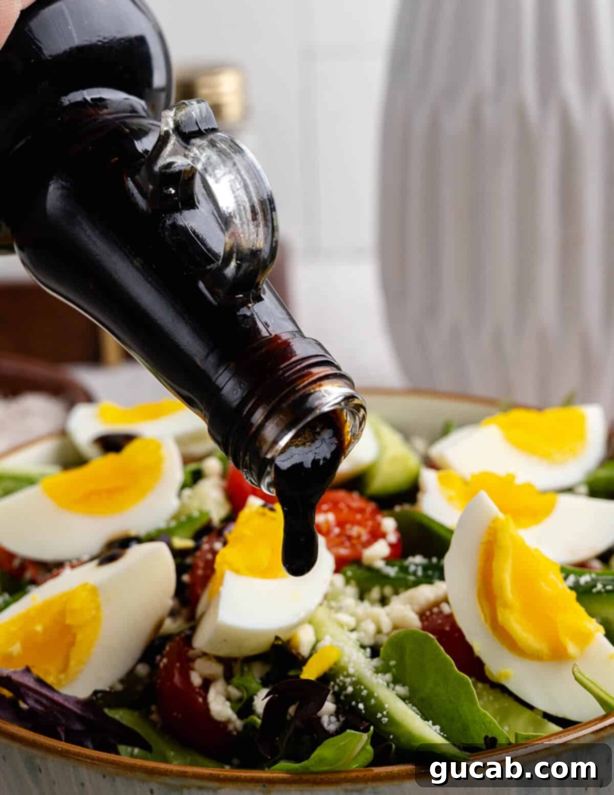 Fig Infusion: A Twist on Vinaigrette 7 Pouring fig jam vinaigrette onto a fresh salad