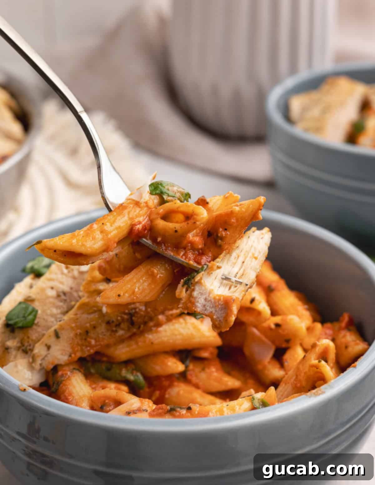 A tempting forkful of vodka pasta and tender chicken.