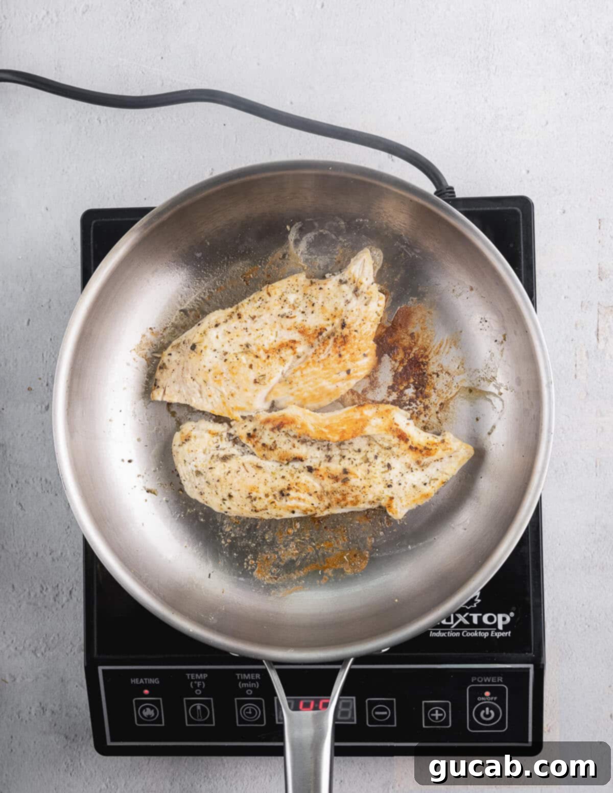 Perfectly seared chicken breasts in a skillet.
