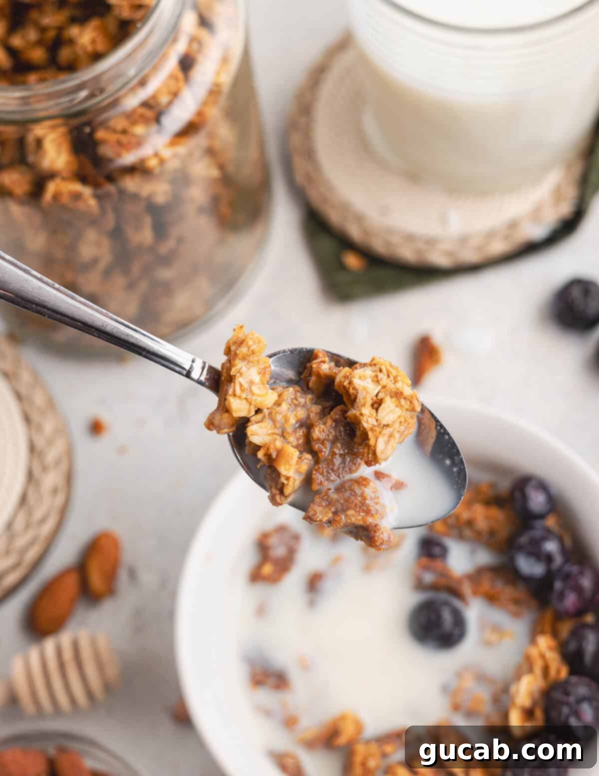 Almond Butter Crunch Granola 4 A spoonful of homemade almond butter granola, highlighting the clusters, almonds, and golden-brown color