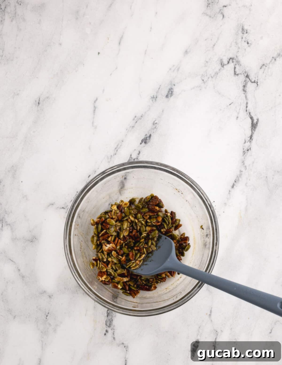 Pomegranate Pear Salad with Candied Pumpkin Seeds 4 A bowl of pepitas, pecans, and sugar.
