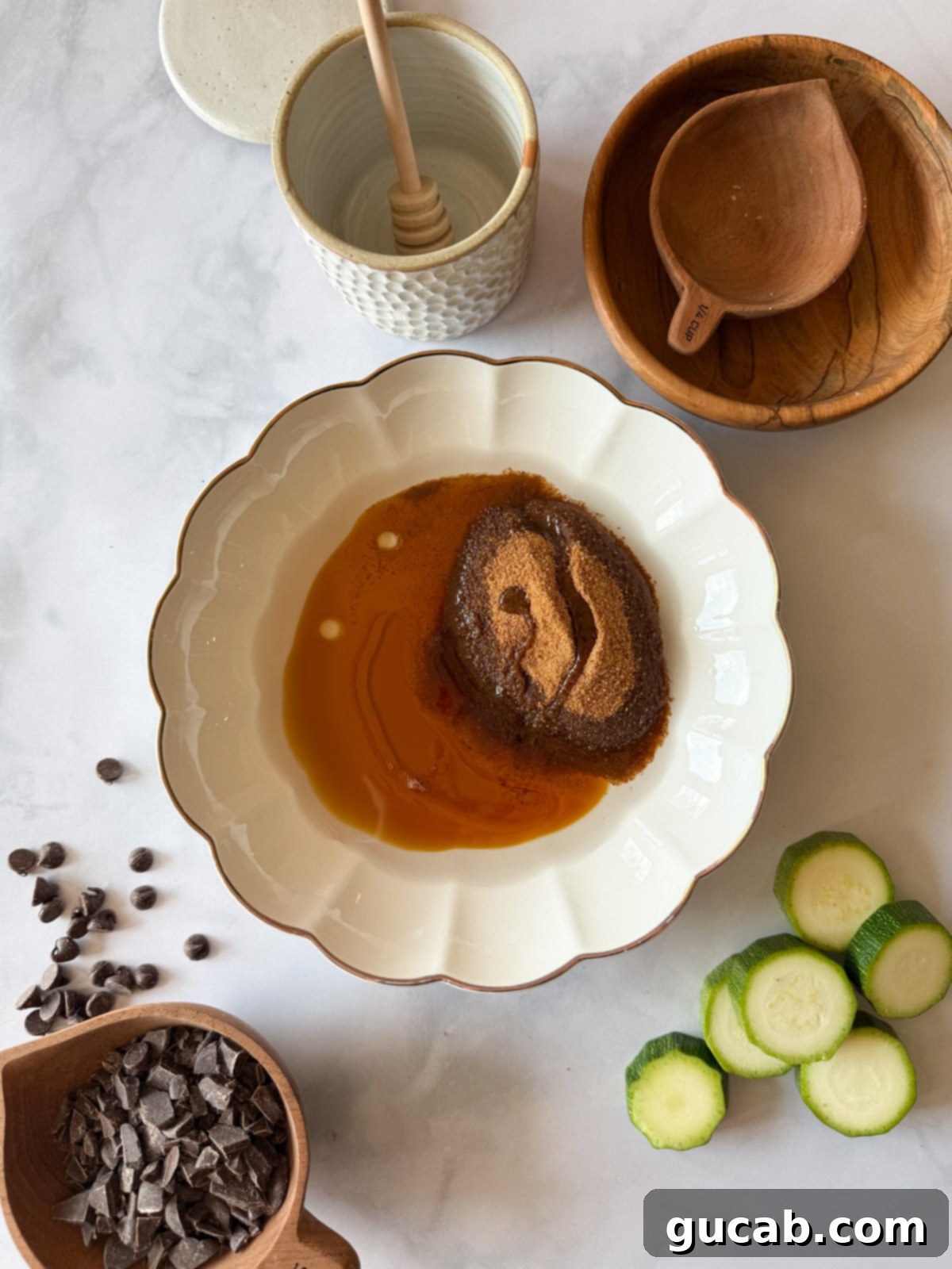 Heartwarming Zucchini Muffins 5 A bowl with melted coconut oil, coconut sugar, and maple syrup, ready to be mixed into a smooth base.