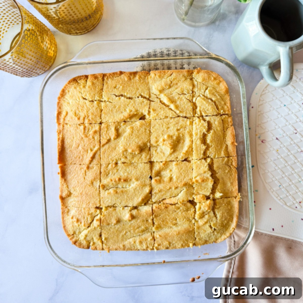 Slices of gluten-free cornbread in a baking dish, ready to be served.