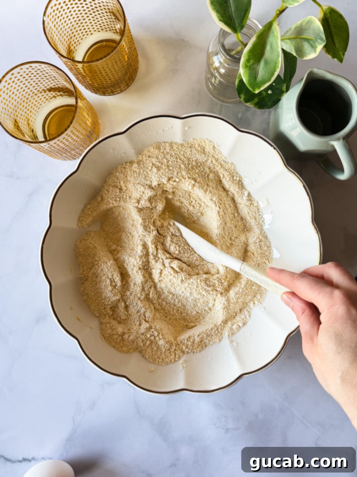 Dry ingredients for gluten-free cornbread mixed together in a bowl.
