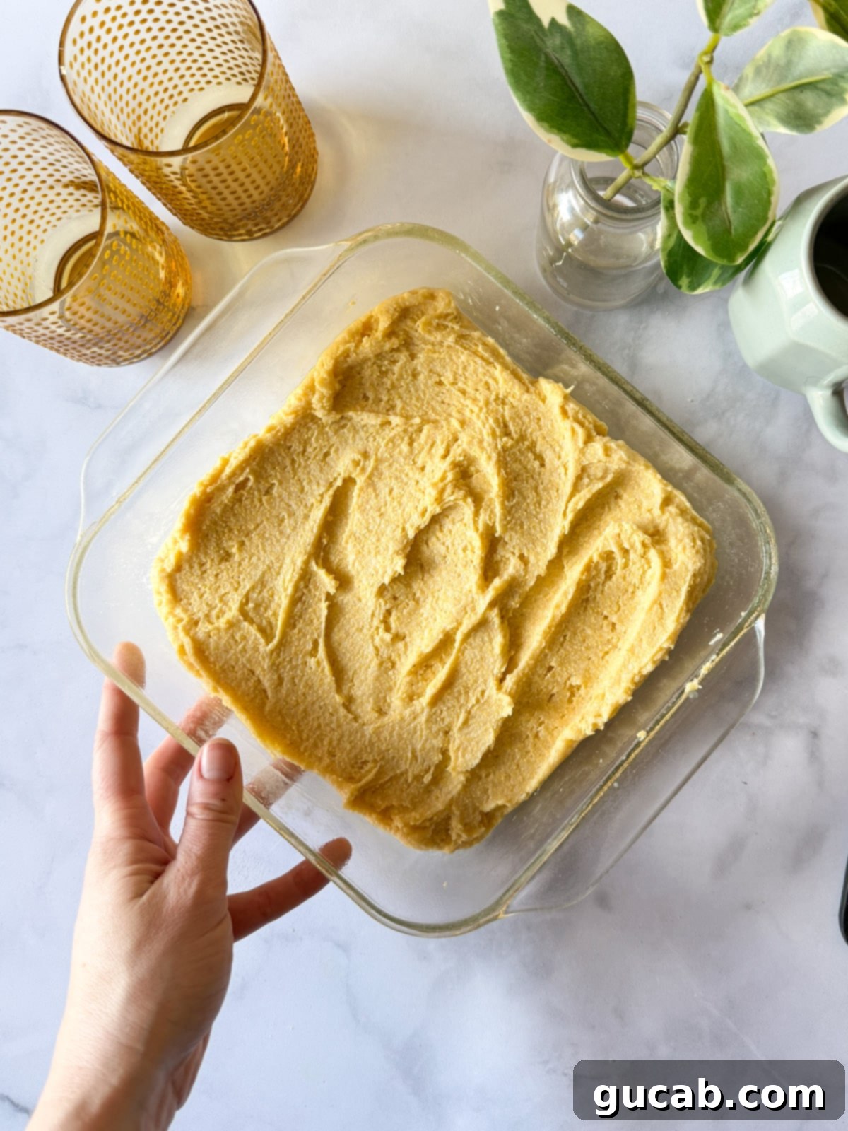 Unbaked gluten-free cornbread batter in a baking dish.