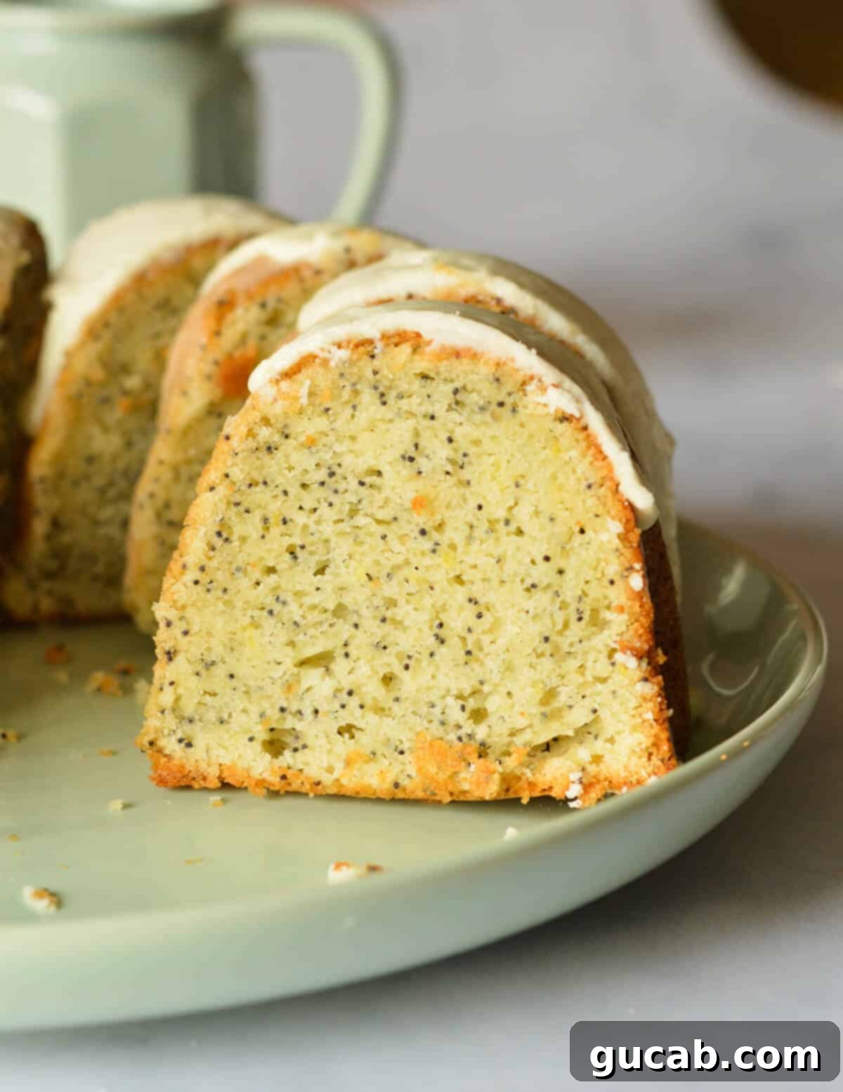Lemon Poppyseed Bliss: A Gluten-Free Delight 2 A slice of gluten-free lemon poppyseed cake on a plate, showcasing its moist crumb and tangy glaze.