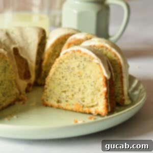 A tempting piece of lemon poppyseed cake on a plate, showcasing its moist crumb and glaze.