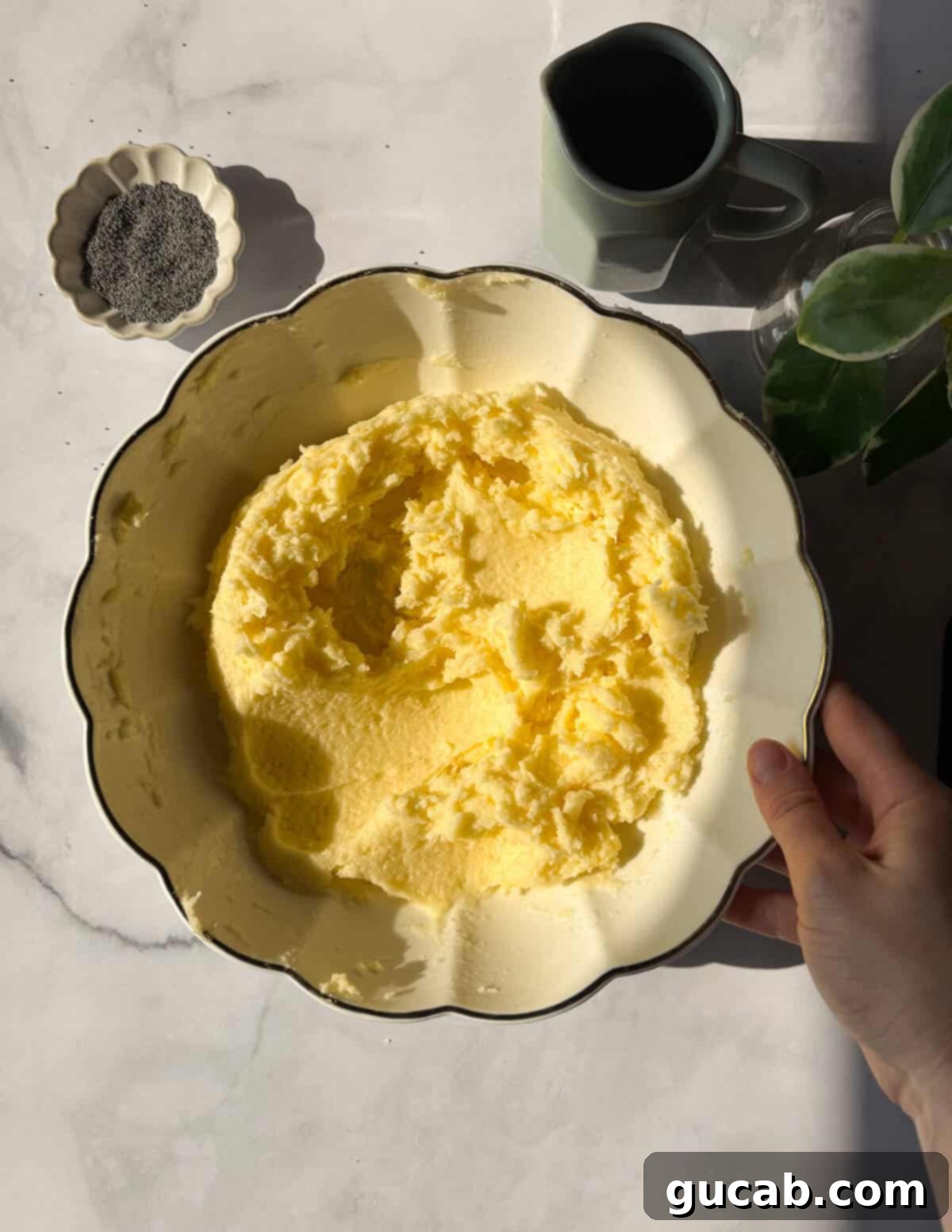 Lemon Poppyseed Bliss: A Gluten-Free Delight 7 A bowl of creamed butter, sugar, and eggs, showing a smooth and creamy consistency.