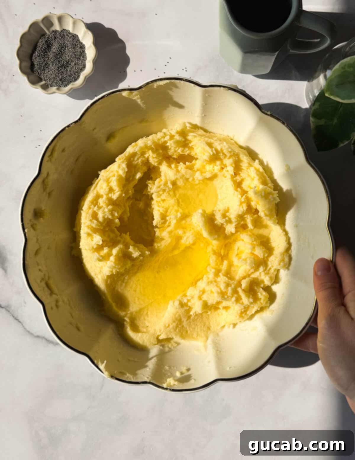 Lemon Poppyseed Bliss: A Gluten-Free Delight 8 A bowl of creamed butter, sugar, and eggs with egg whites on top, ready to be mixed in.