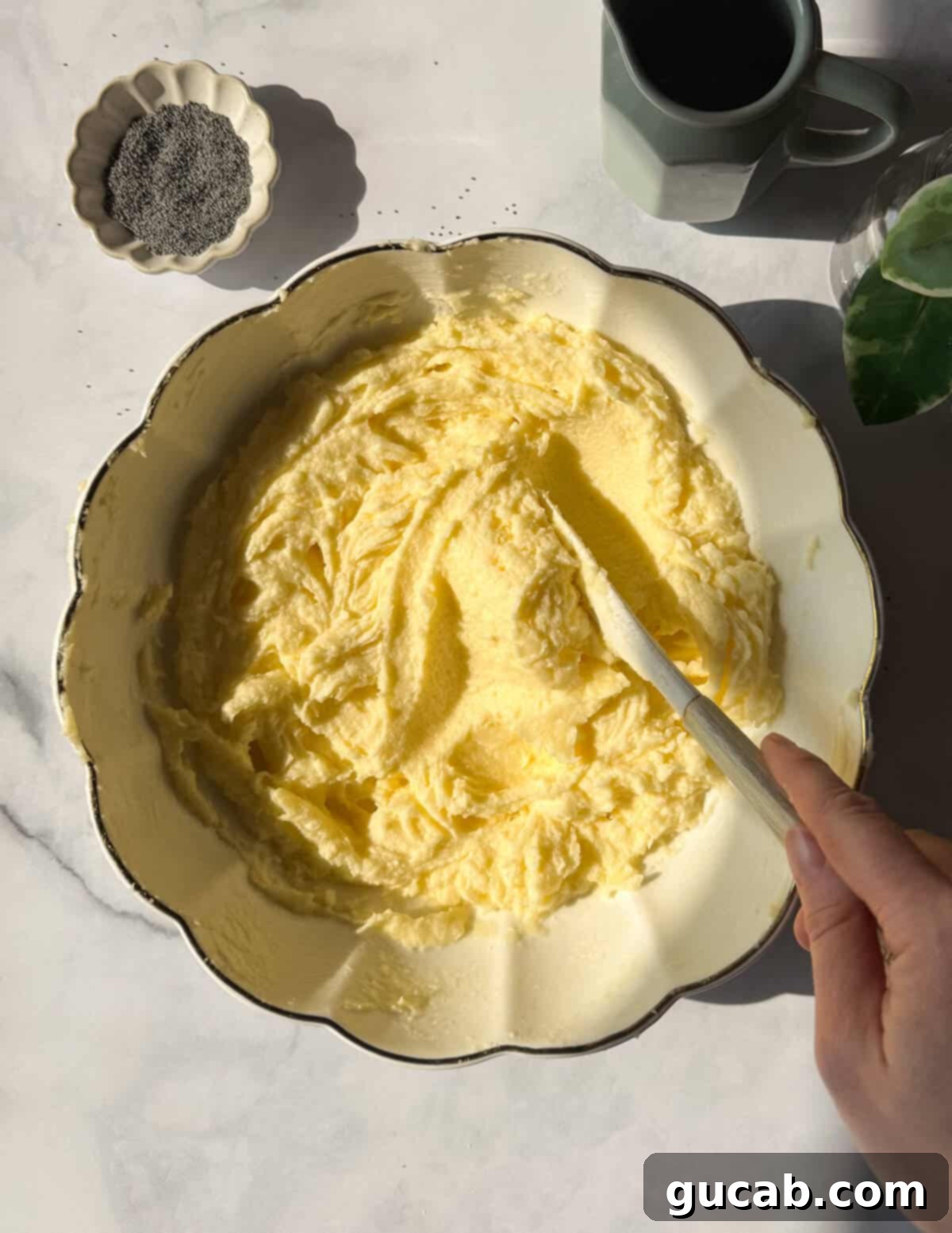 Lemon Poppyseed Bliss: A Gluten-Free Delight 9 A bowl of creamed butter, sugar, and egg whites, showing a light and airy mixture.