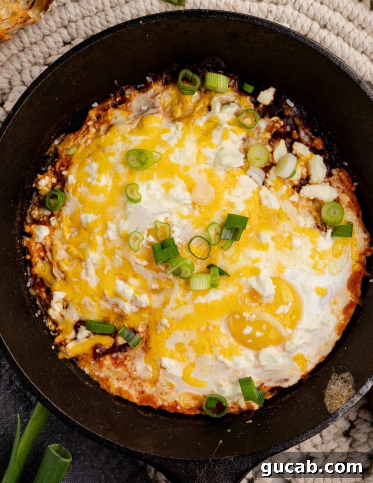 Eggs Fiesta: A Zesty Morning Kickstart 2 A skillet brimming with salsa, eggs, and a blanket of melted cheese.