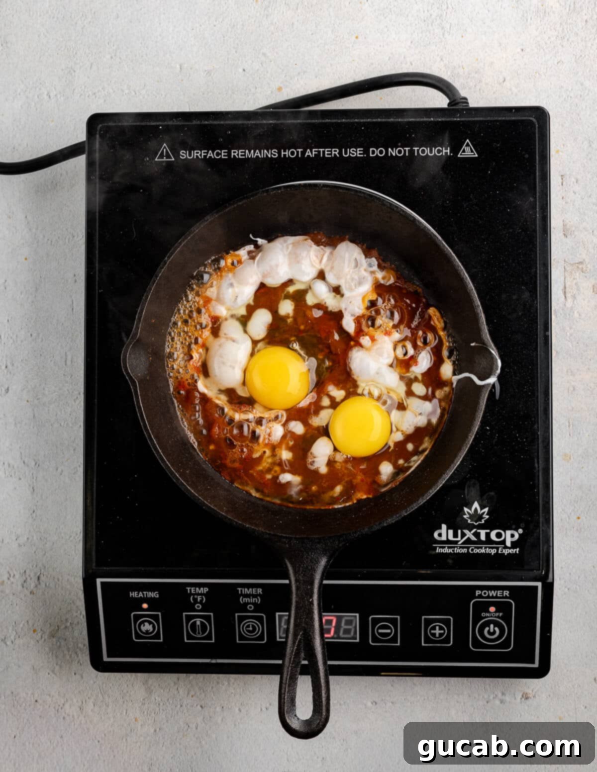 Eggs Fiesta: A Zesty Morning Kickstart 5 Salsa and eggs in a small skillet, ready for baking.