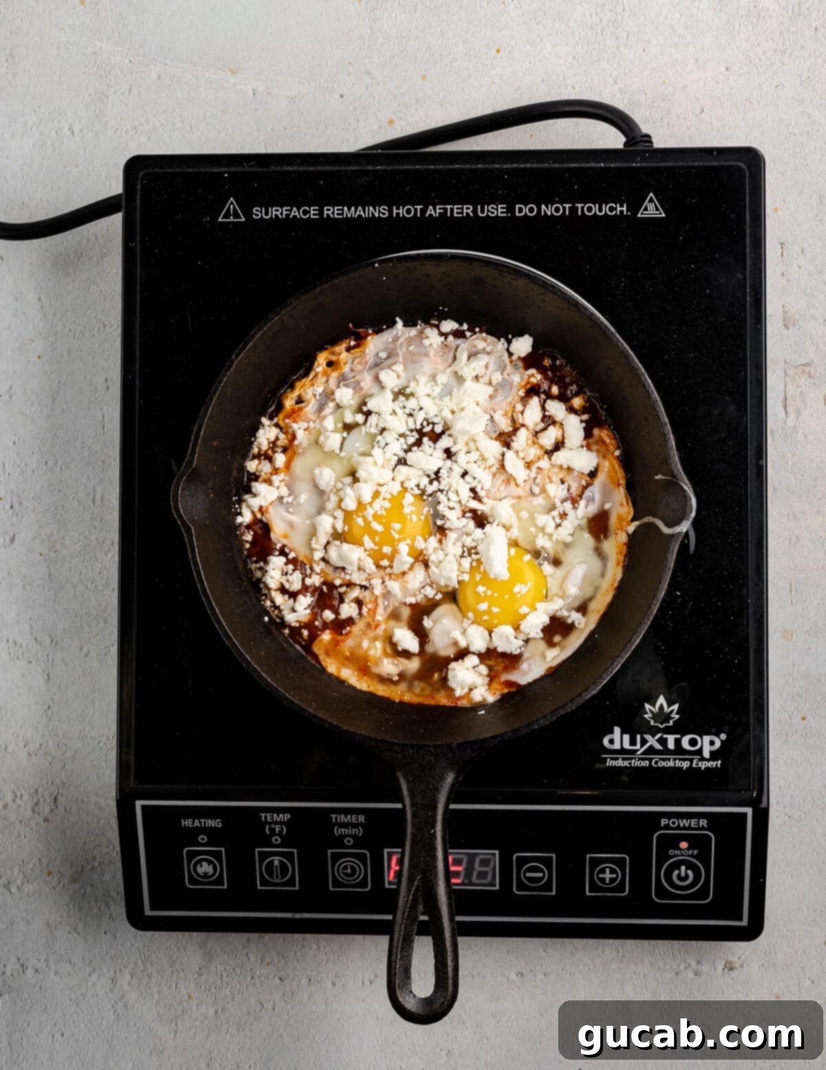 Eggs Fiesta: A Zesty Morning Kickstart 6 Salsa, eggs, and cheese layered in a small skillet.