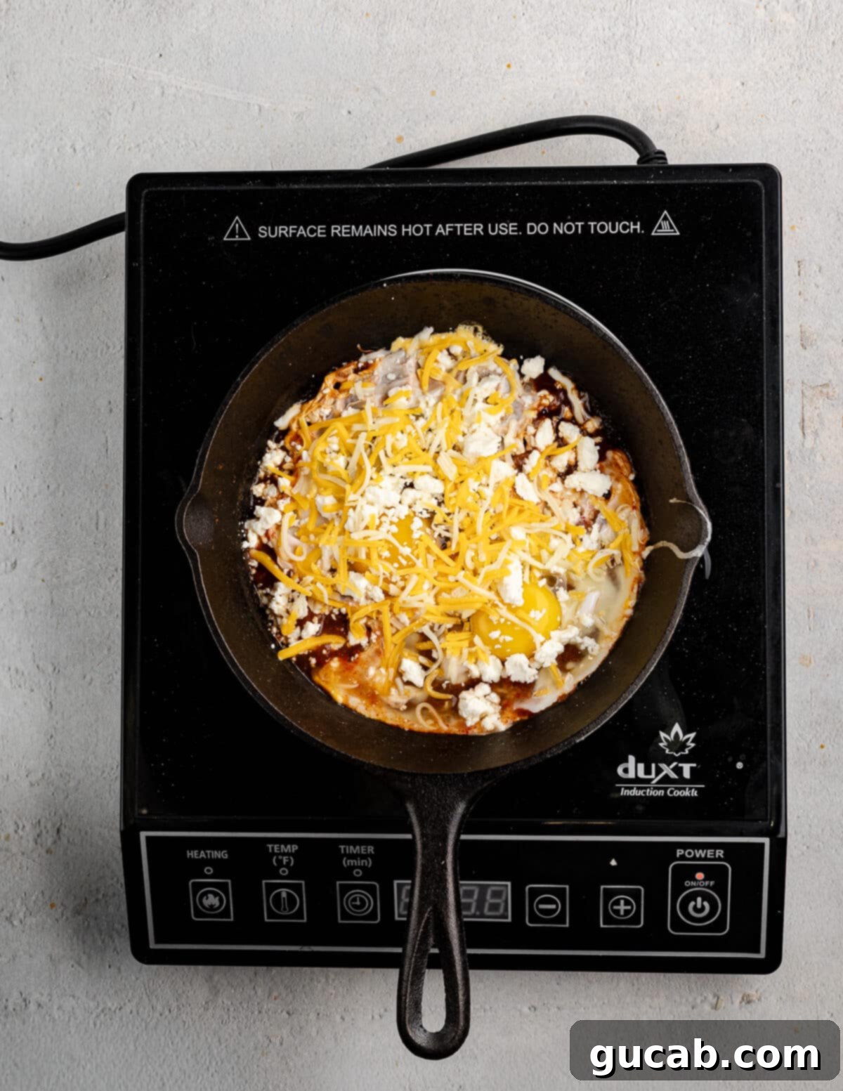 Eggs Fiesta: A Zesty Morning Kickstart 7 A variety of cheeses, including feta and shredded Mexican cheese, topping the salsa and eggs.