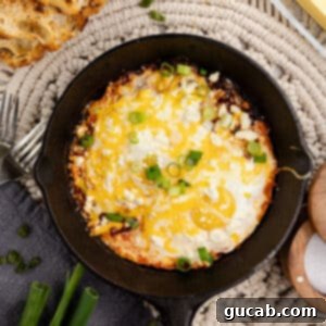 Close-up of delicious eggs with salsa in a skillet.