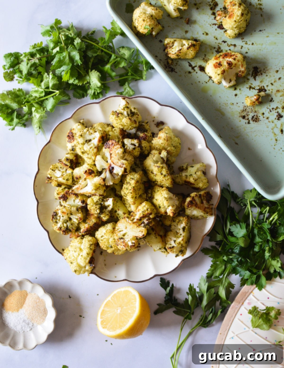 Herb-Crusted Roasted Cauliflower 2 A plate of perfectly herb roasted cauliflower, showcasing its golden-brown edges and vibrant green herbs.